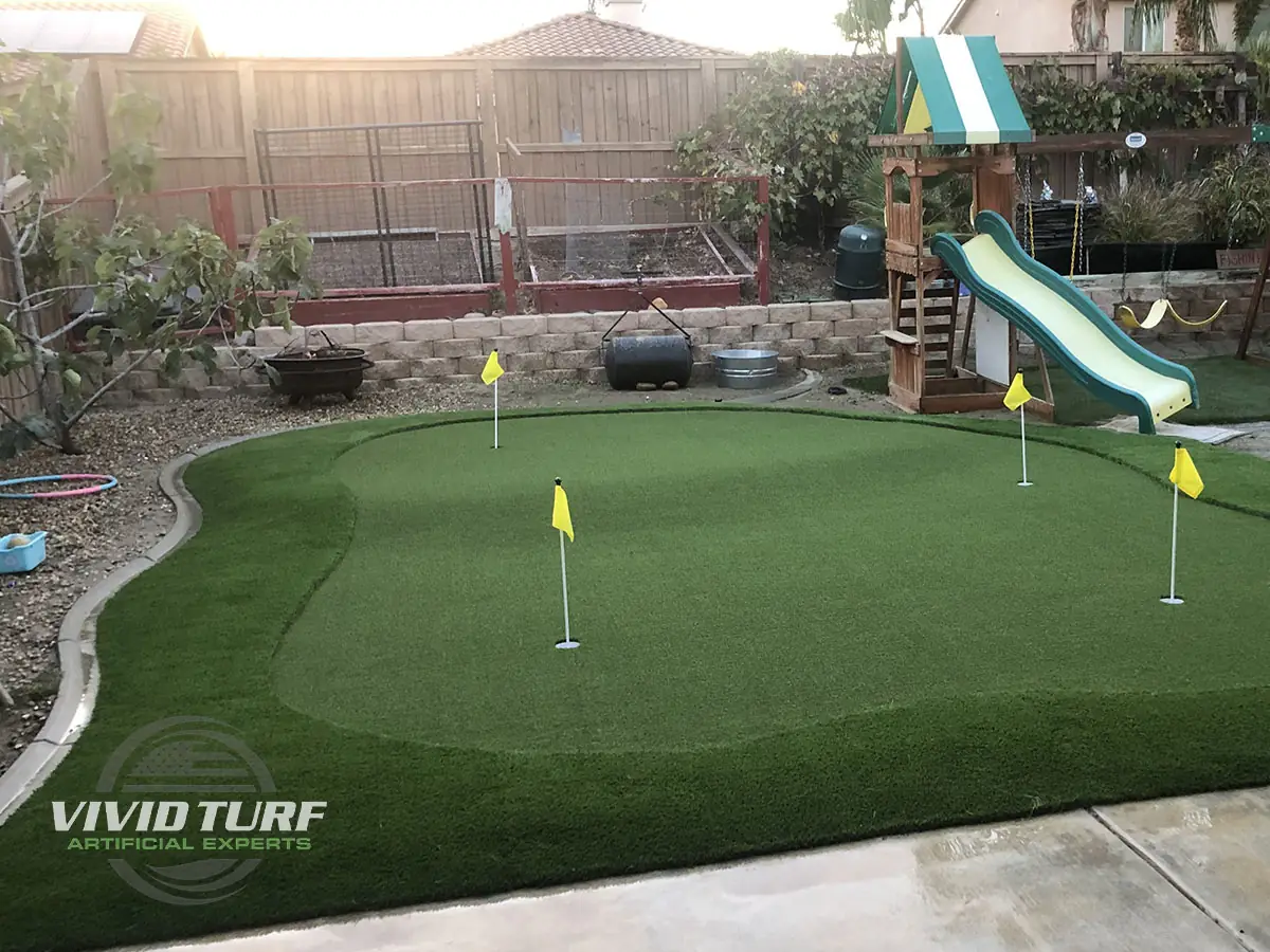 Backyard putting green next to the play area